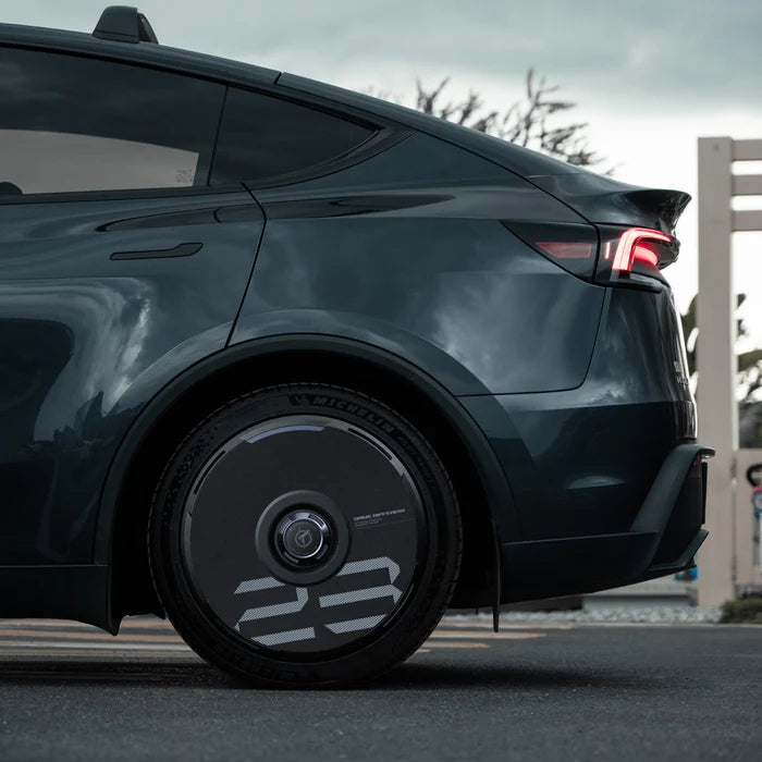HALODISC 2 black wheel cover with custom number and blue accent ring on a Tesla Model Y rear wheel